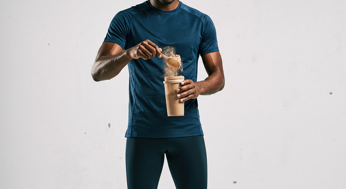 A runner scooping protein powder.